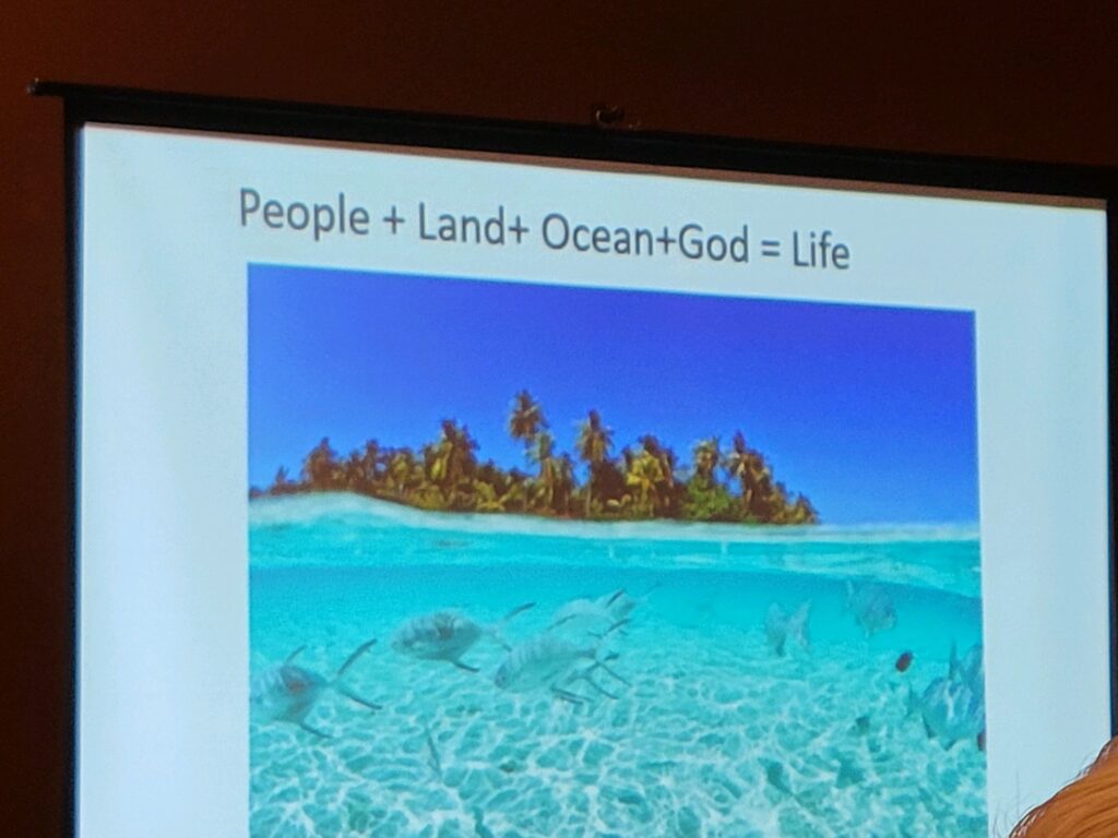 Presentation slide saying people + land + oceans + God = life
