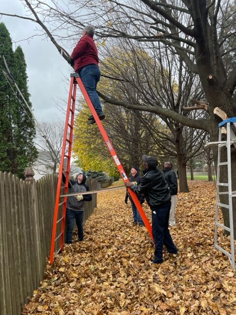 volunteers on a ladder