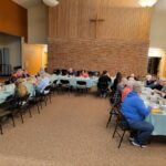 Community Members sharing a meal in the FPCD Fellowship Hall