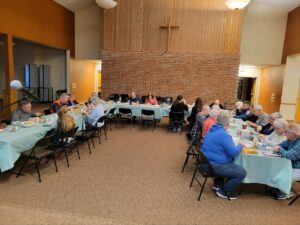 Community Members sharing a meal in the FPCD Fellowship Hall