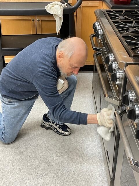 Bob cleaning stove