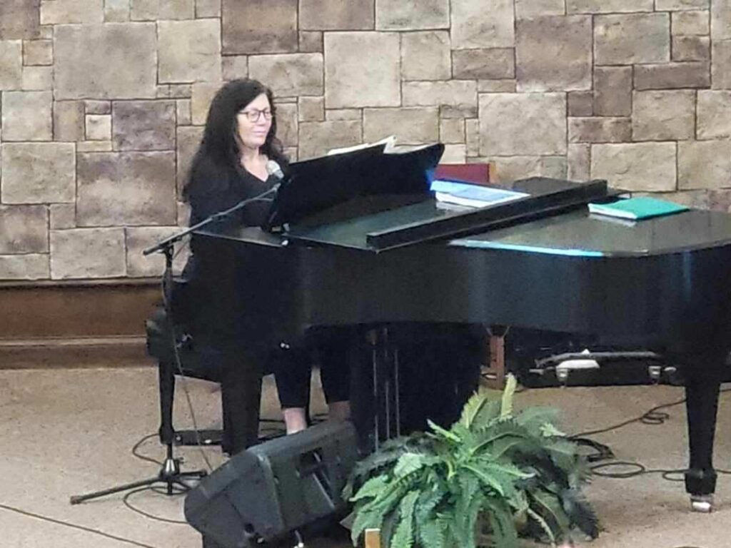 Music Director playing piano