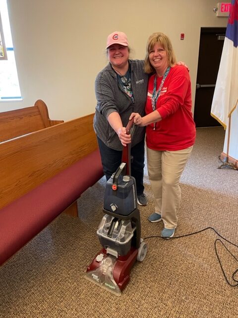 two women vacuuming