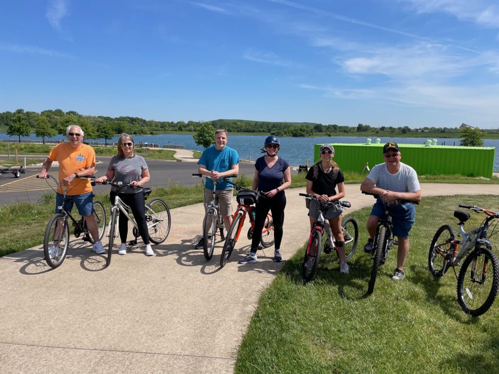 people with bikes by a lake