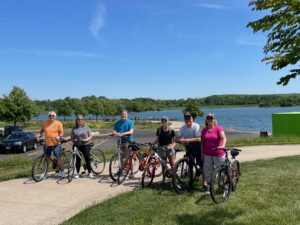 people with bikes by a lake