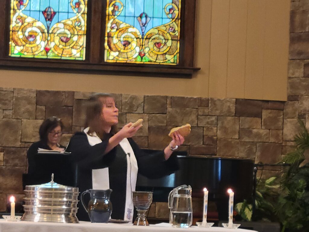 Pastor KJ giving Communion