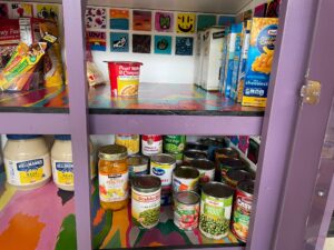 Micro Pantry inside view with food and small paintings made by kids