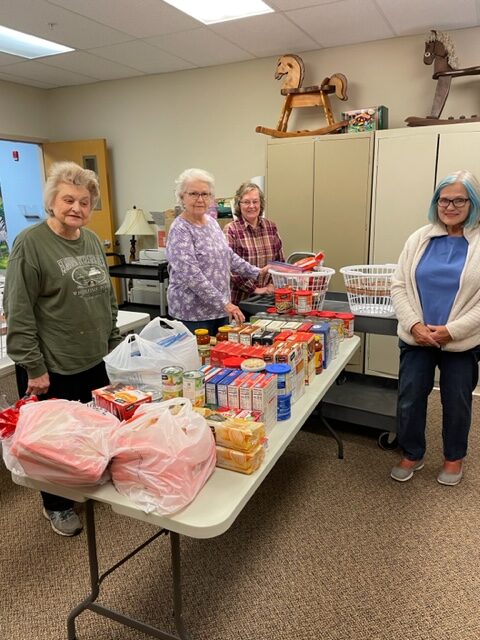 Women creating food baskets for distribution