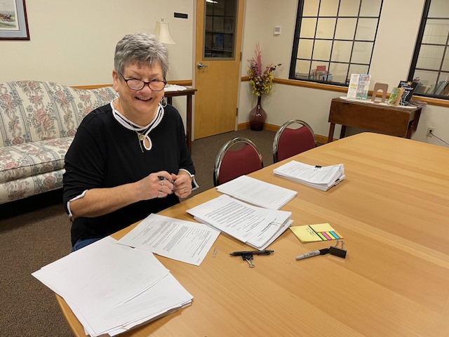 Deb signing papers