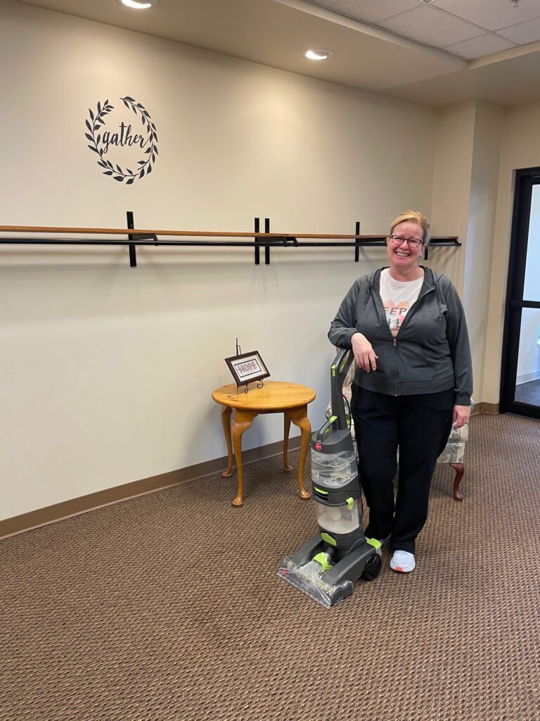 Katrina cleaning the carpet