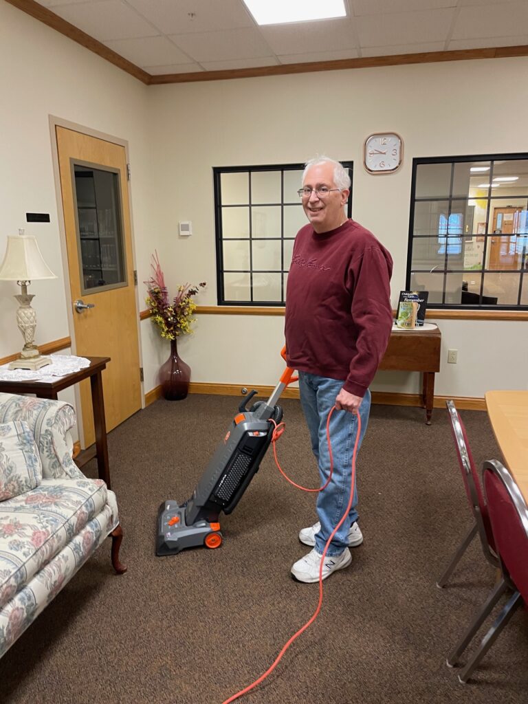 John vacuuming