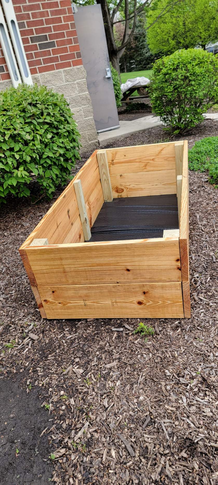 close up image of garden bed made out of plywood
