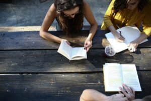 people studying at a picnic table by alexis-brown-omea-unsplash